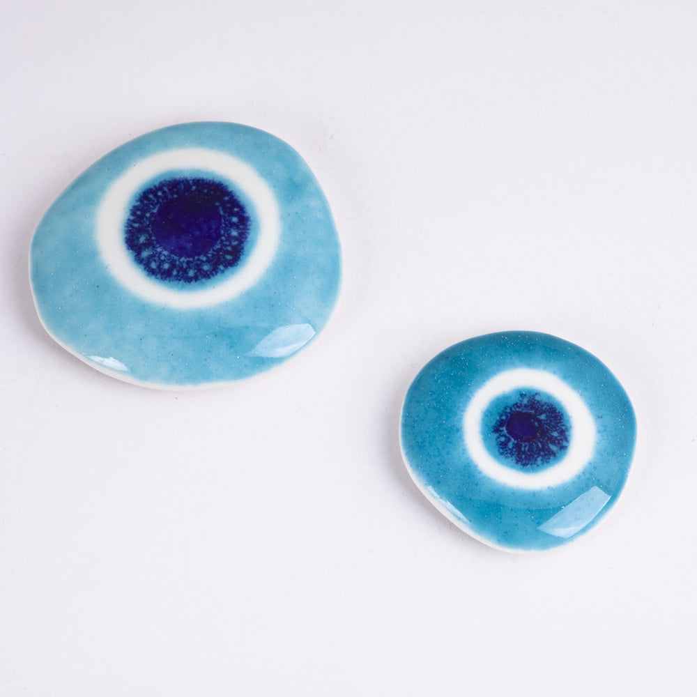 
                
                    Load image into Gallery viewer, Ceramic Pebbles Set with Evil Eye
                
            